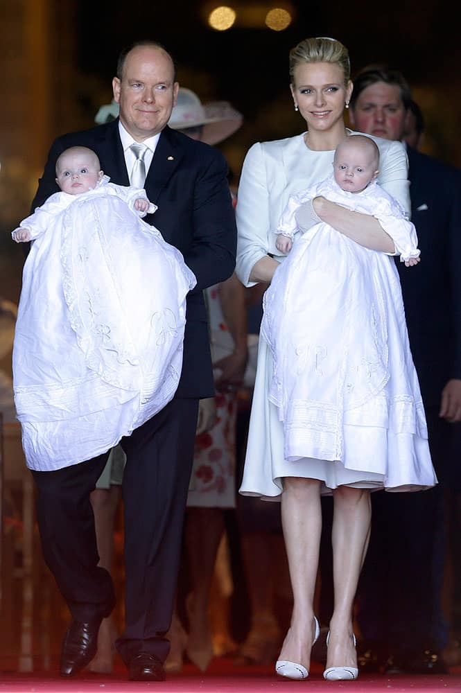 Prince Albert II of Monaco and his wife Princess Charlene pose with their twins babies Princess Gabriella, left, and Prince Jacques, right, after their baptism ceremony in the Cathedral of Monaco.