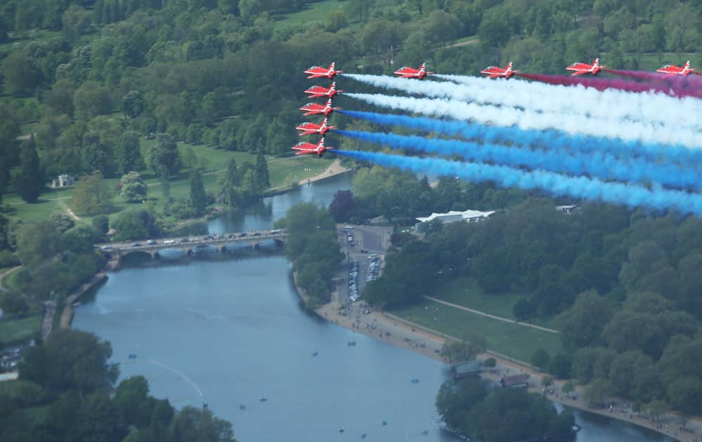 Britain's Royal Air Force aerobatic team the Red Arrows perform a fly past over The Serpentine in Hyde Park, London to mark the 70th anniversary of Victory in Europe (VE) Day.