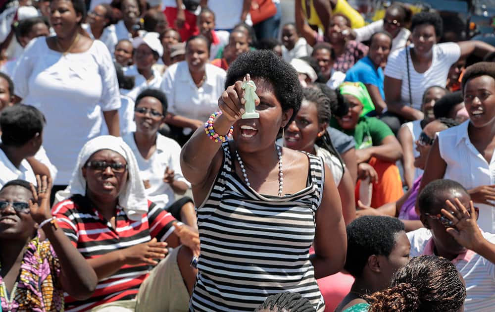 A Christian woman who chose to protest instead of going to Sunday mass holds a figurine of Jesus Christ as she attends a demonstration to coincide with Mother's Day, against a third term for President Pierre Nkurunziza, and calling for the release of protesters arrested during demonstrations, in the capital Bujumbura, Burundi.