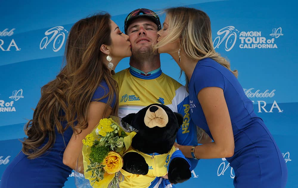 Mark Cavendish is congratulated while wearing the yellow jersey he received for winning the first stage of the Amgen Tour of California cycling race in Sacramento, Calif.