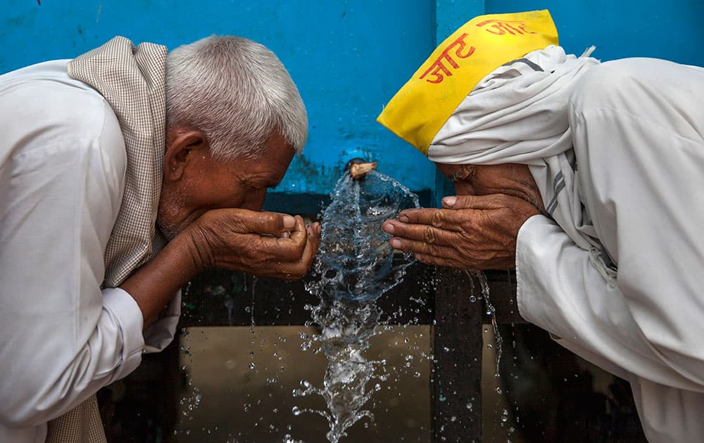 Members of the Indian Jat community drink water from a tanker during a protest in New Delhi, India.