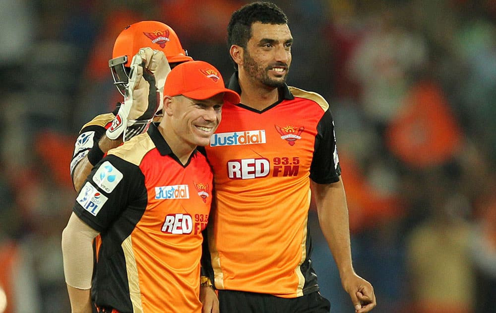 David Warner and Bipul Sharma of the Sunrisers Hyderabad celebrates wicket of Manan Vohra of Kings XI Punjab in Hyderabad.