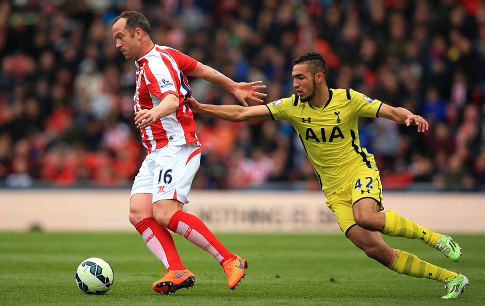 Stoke City's Charlie Adams and Tottenham Hotspur's Nabil Bentaleb battle for the ball during their English Premier League soccer match at the Britannia Stadium, Stoke On Trent, England.