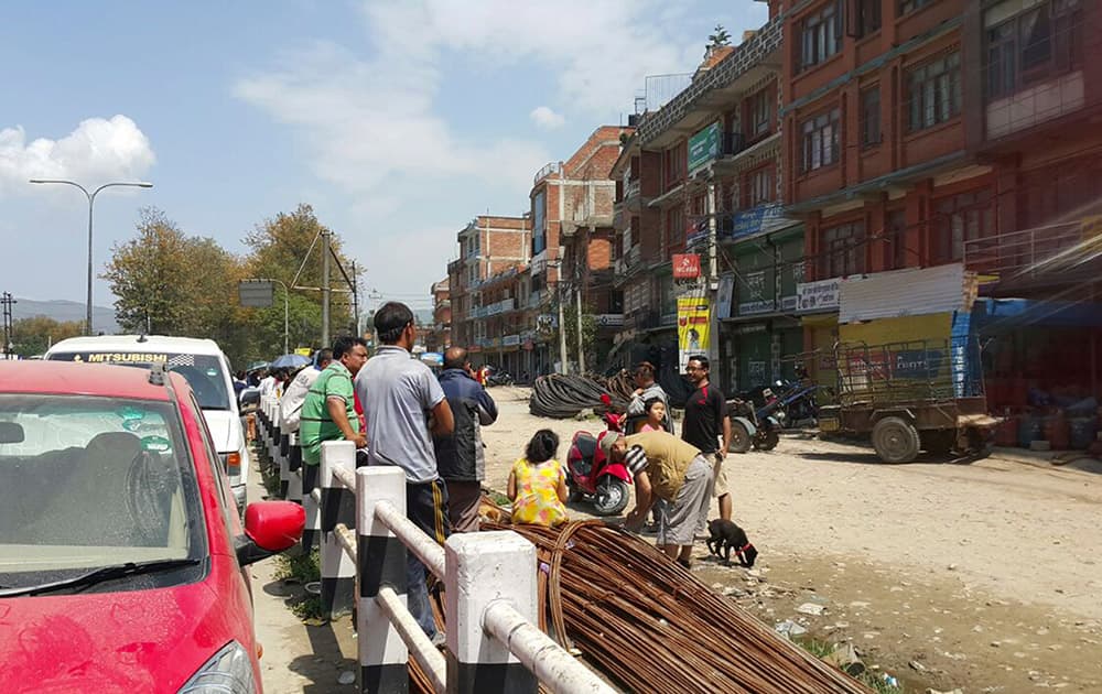 Nepalese people gather outdoors after another earthquake in Bhaktapur, Nepal.