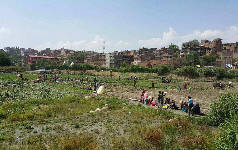 Nepalese people gather outdoors after another earthquake in Bhaktapur, Nepal.