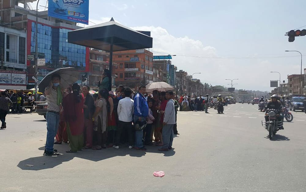 Nepalese people gather in the middle of a road during an earthquake in Bhaktapur, Nepal.