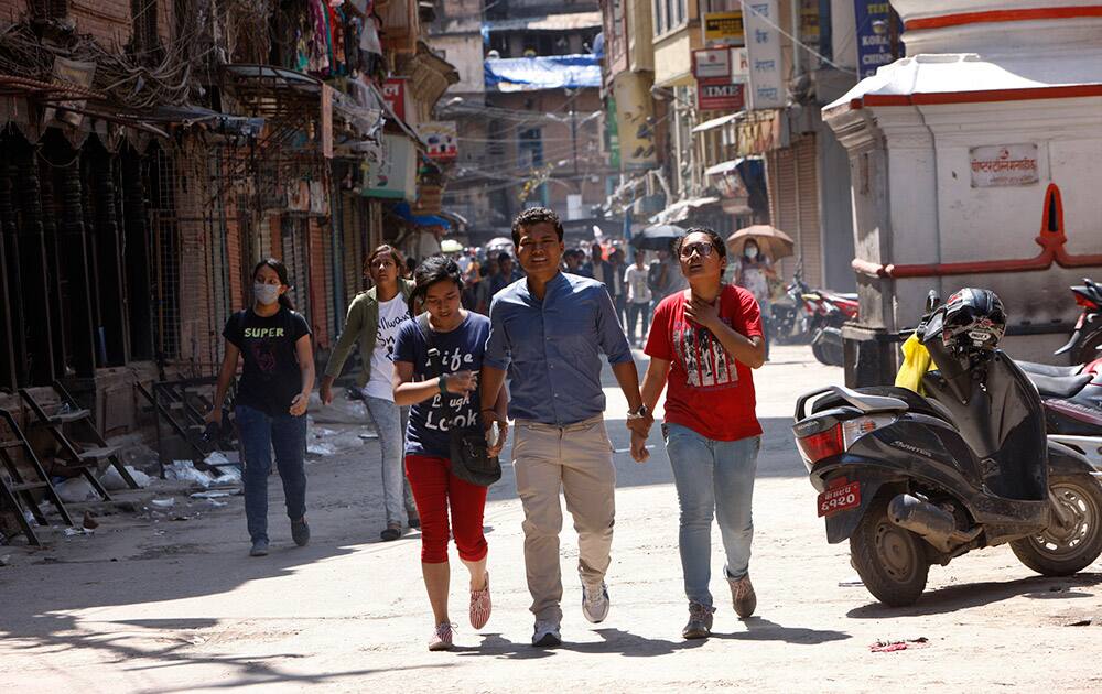 Nepalese people rush to safer areas as an earthquake hits Kathmandu, Nepal