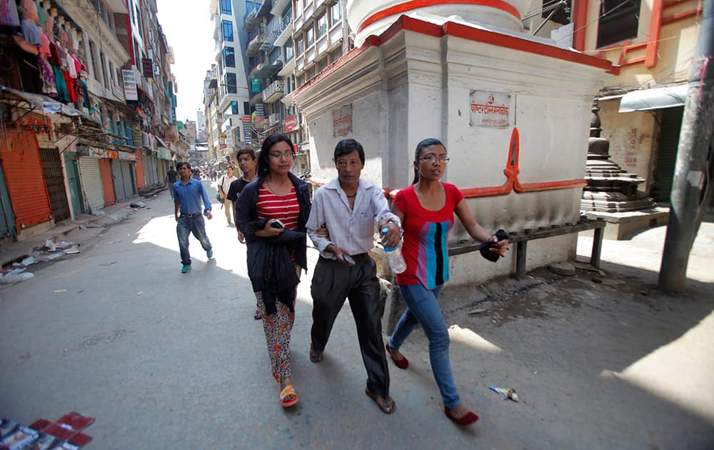 Nepalese people rush to safety after an earthquake hit Nepal in Kathmandu, Nepal.