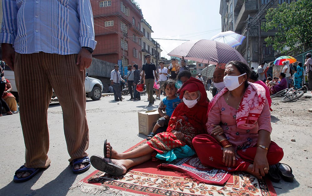 Nepalese people take refuge on a street after an earthquake hit Kathmandu, Nepal.