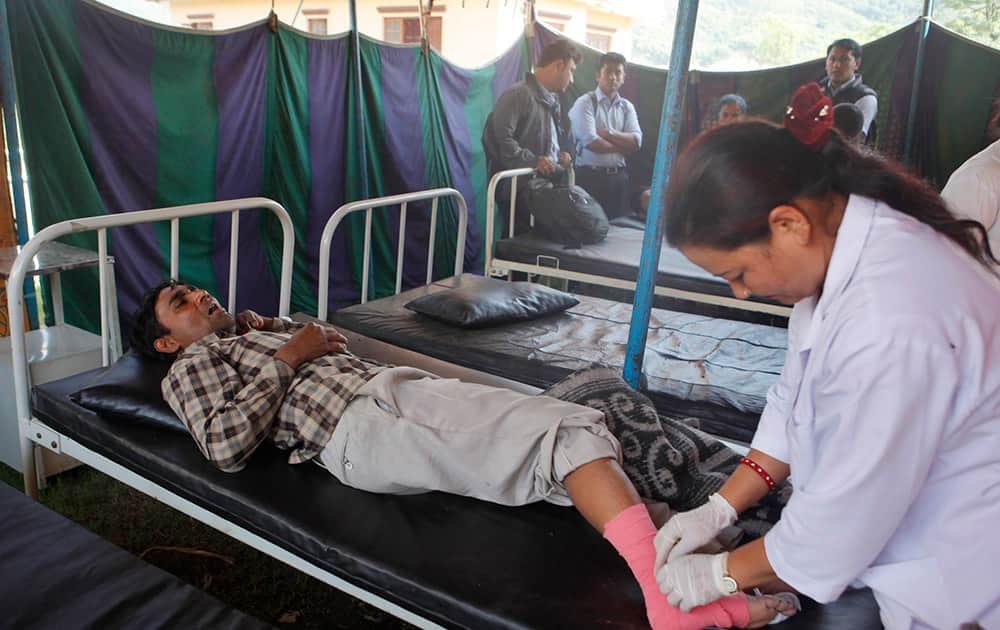 A Nepalese man receives treatment after being injured in an earthquake in Kathmandu, Nepal.