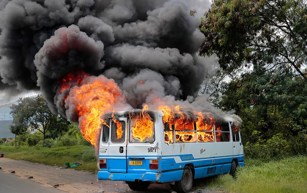 A bus burns after being set on fire by demonstrators in the Ngagara district of Bujumbura, Burundi.