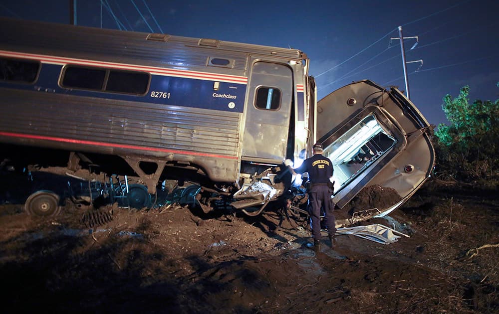 Emergency personnel work the scene of a deadly train wreck, in Philadelphia. An Amtrak train headed to New York City derailed and crashed in Philadelphia. 