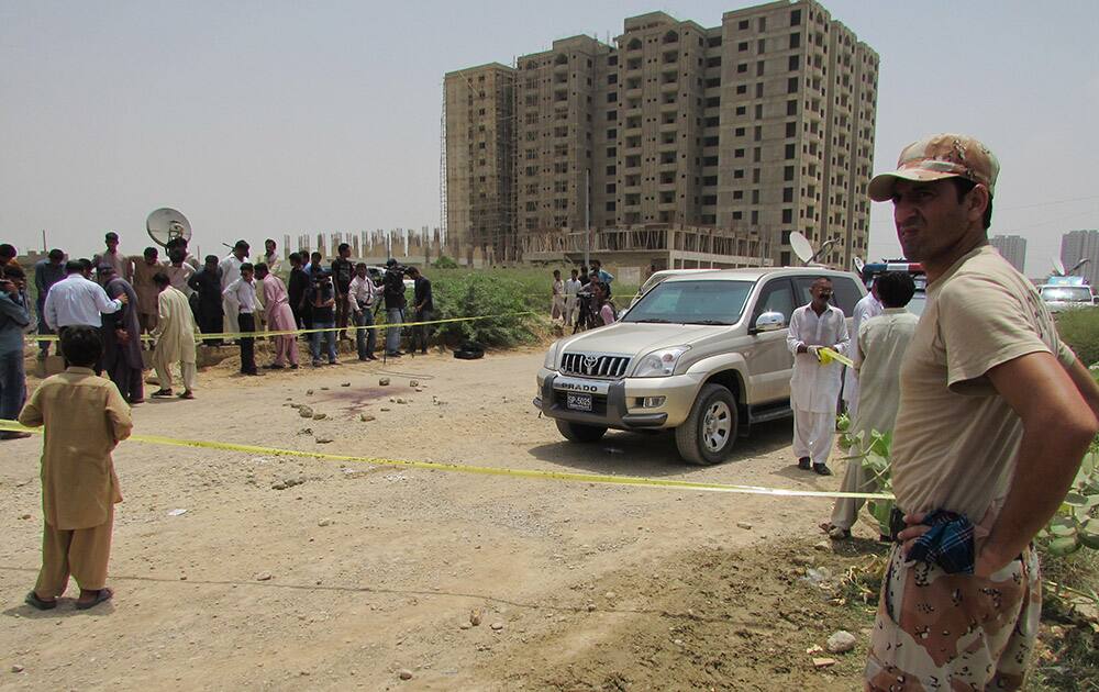 Police cordon off the site of an attack by gunmen in Karachi, Pakistan. The attackers killed dozens of people on Wednesday aboard a bus in southern Pakistan bound for a Shiite community center, in the latest incident targeting the religious minority, police said.