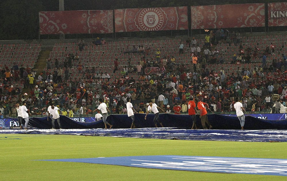  Ground Staff bring the covers on during IPL match between Kings XI Punjab and Royal Challengers Bangalore in Mohali.