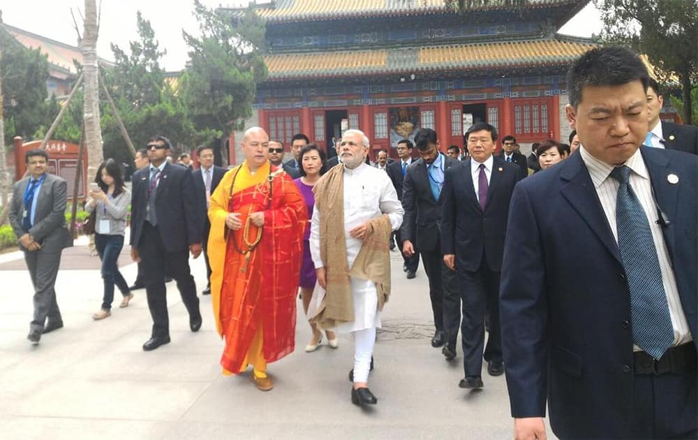 Traversing centuries. From the 2nd century BCE to 2nd century CE. PM @narendramodi at Daxingshan temple . Twitter@PIB_India