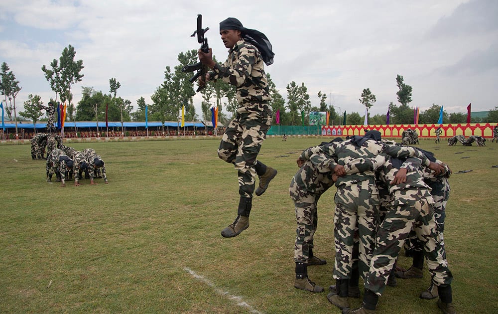 Central Reserve Police Force (CRPF) personnel display their skills during the commencement parade of 341 newly recruited soldiers at a base camp on the outskirts of Srinagar.