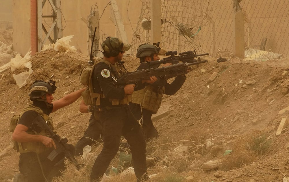 Security forces defend their headquarters against attacks by Islamic State extremists during sand storm in the eastern part of Ramadi, the capital of Anbar province, 115 kilometers (70 miles) west of Baghdad