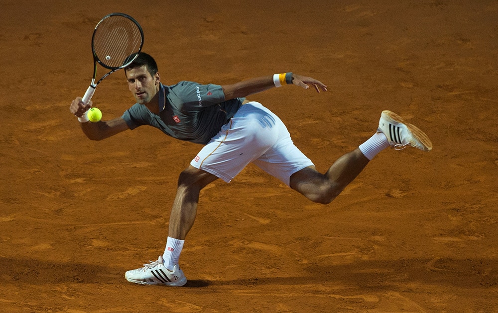 Novak Djokovic, of Serbia, returns the ball to Thomaz Bellucci, of Brazil, during their match at the Italian Open tennis tournament, in Rome