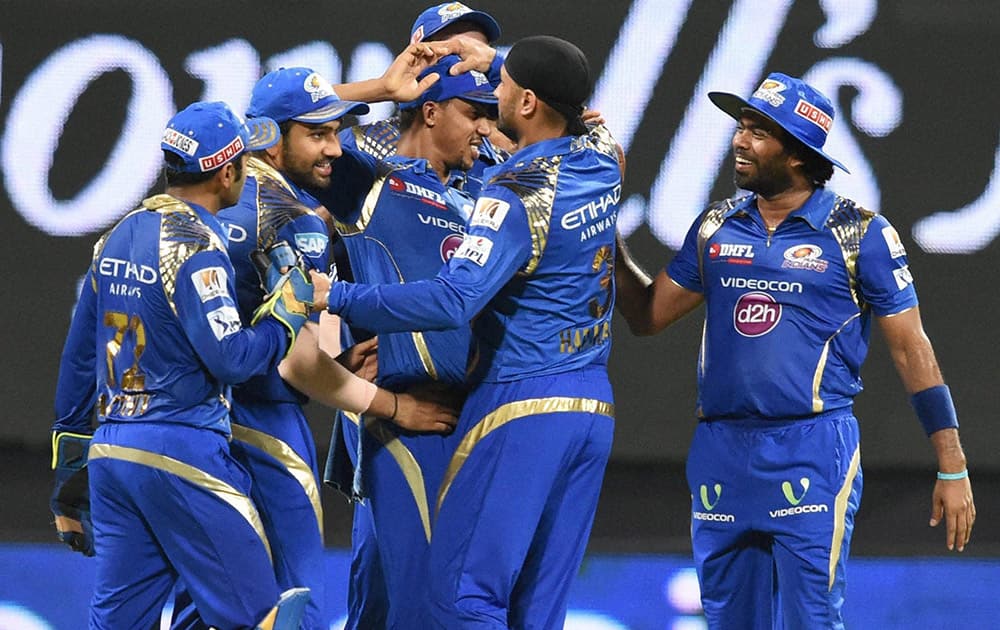 Mumbai Indians players celebrates a wicket of Kolkata Knight Riders batsman during an IPL T20 match in Mumbai.