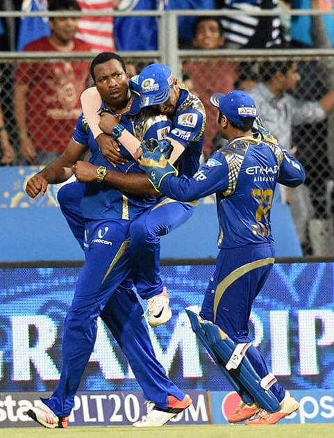 Mumbai Indians players celebrate their win against Kolkata Knight Riders during an IPL T20 match in Mumbai.