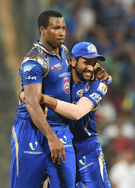 Mumbai Indians players K Pollard and Rohit Sharma celebrate their win against Kolkata Knight Riders during an IPL T20 match in Mumbai.