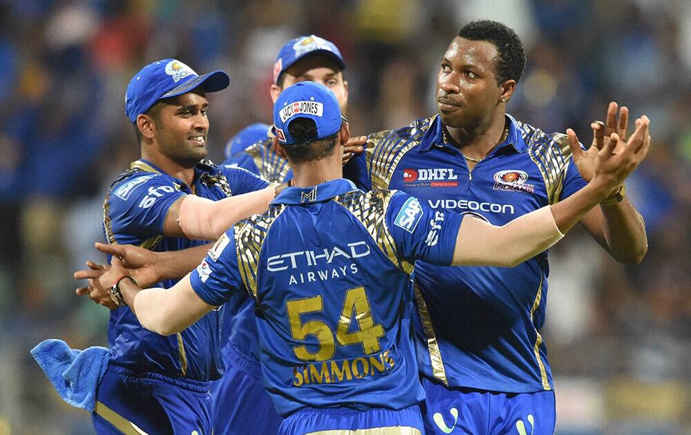 Mumbai Indians players celebrate their win against Kolkata Knight Riders during an IPL T20 match in Mumbai.