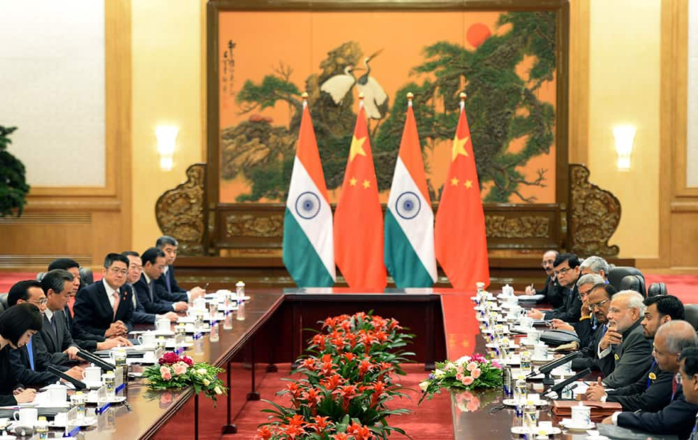 Prime Minister Narendra Modi, talks with Chinese Premier Li Keqiang, during a meeting at the Great Hall of the People in Beijing, China.