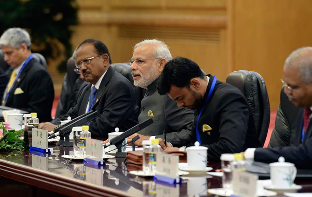 Prime Minister Narendra Modi, talks with Chinese Premier Li Keqiang during a meeting at the Great Hall of the People in Beijing.