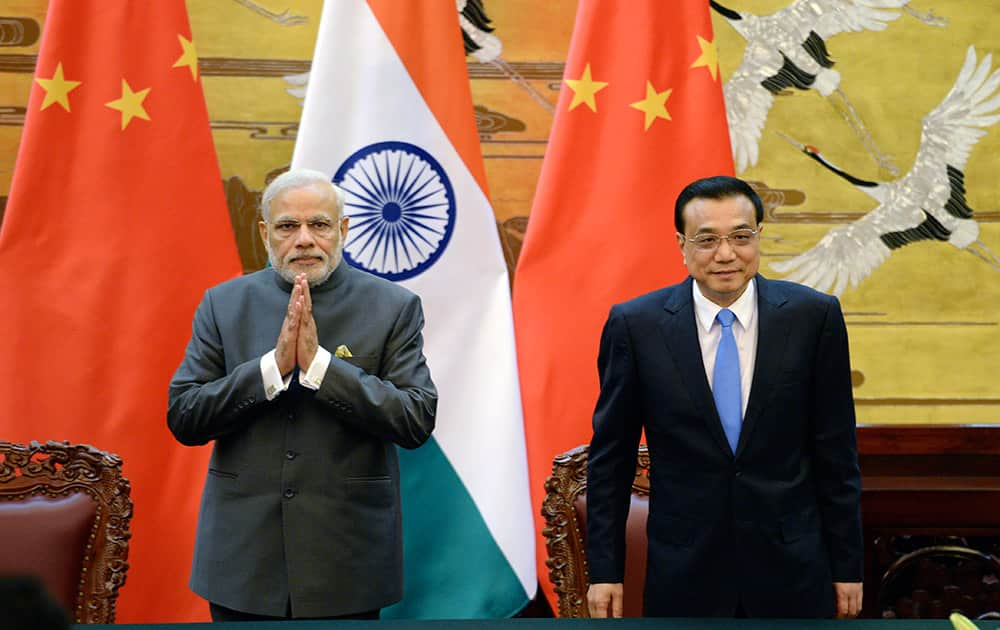 Chinese Premier Li Keqiang and Indian Prime Minister Narendra Modi attend a signing ceremony at the Great Hall of the People in Beijing, China.