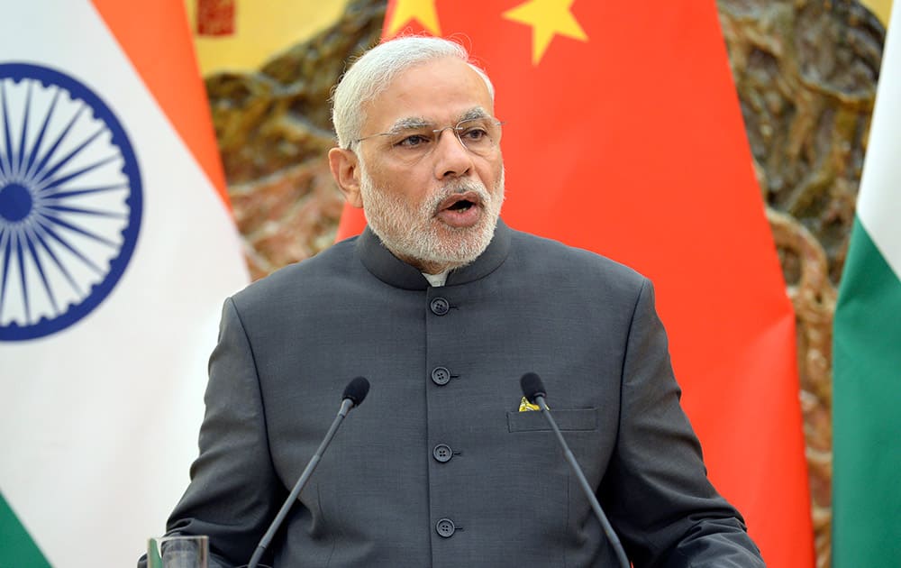 Prime Minister Narendra Modi speaks during a press conference at the Great Hall of the People in Beijing, China.