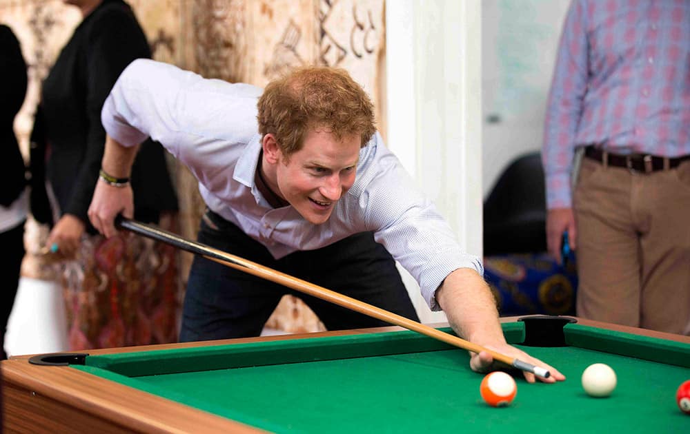 Britain's Prince Harry plays pool while visiting the Turn Your Life Around youth center in Auckland, New Zealand.