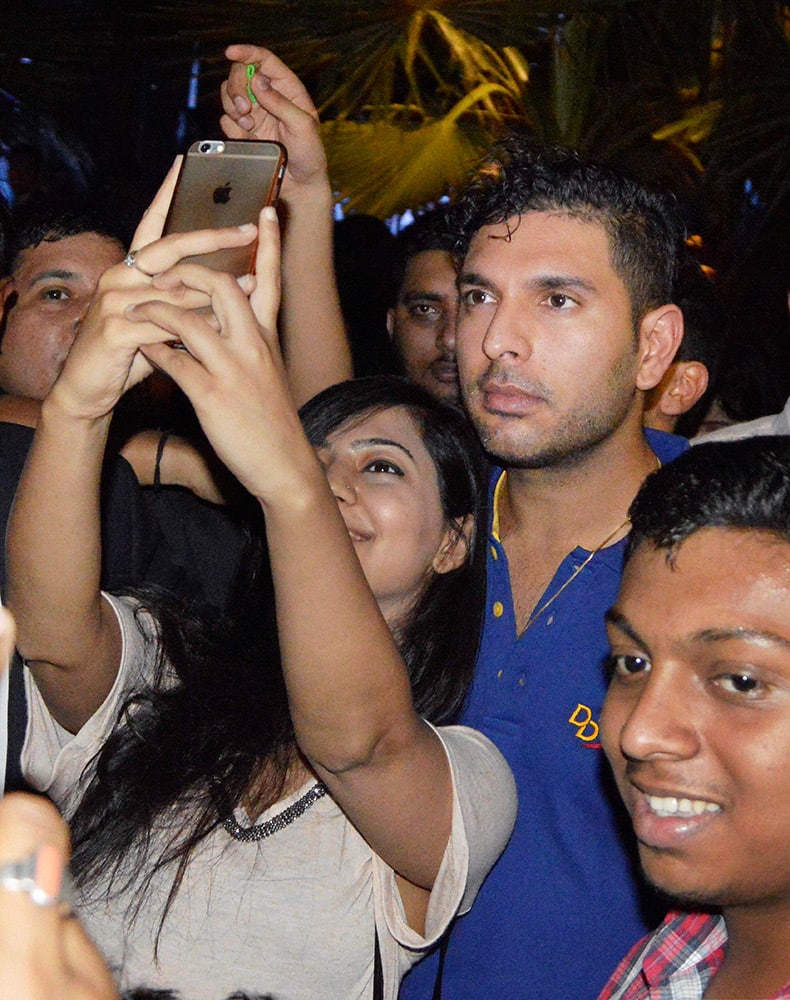 A fan takes selfies with Delhi Daredevils player Yuvraj Singh in New Delhi.