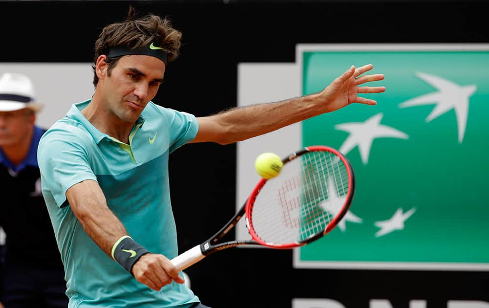 Roger Federer, of Switzerland, returns the ball to Tomas Berdych, of Czech Republic, during a quarter final match at the Italian Open tennis tournament, in Rome.