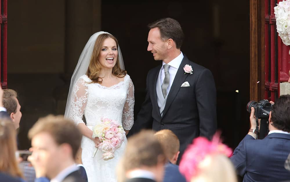 Spice Girl Geri Halliwell and her new husband, Formula 1 boss Christian Horner, after their wedding at St Mary's Church in Woburn, England.