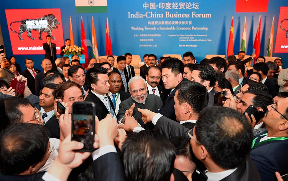 Prime Minister Narendra Modi shaking hands with business leaders at the India-China Business Forum in Shanghai.