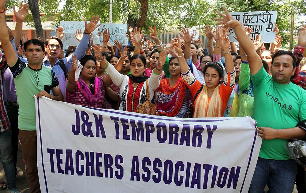 Members of the J&K Temporary Teachers Association shout slogans during a protest against the state government in Jammu