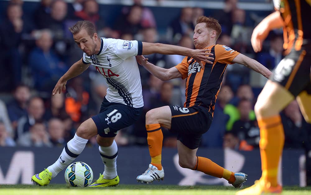 Hull City's Stephen Quinn, slides in on Tottenham Hotspur's Harry Kane during their English Premier League soccer match at White Hart Lane, London.