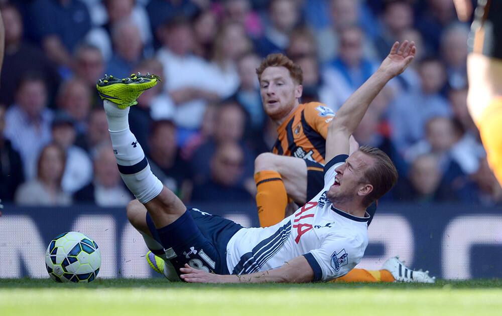 Hull City's Stephen Quinn, behind, brings down Tottenham Hotspur's Harry Kane during their English Premier League soccer match at White Hart Lane, London.