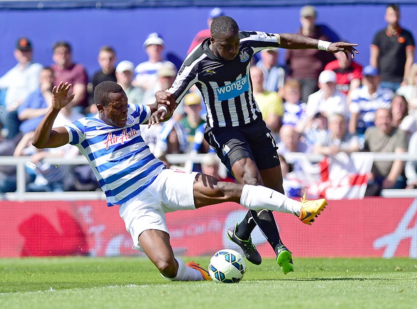 Queens Park Rangers' Nedum Onuoha, left, challenges Newcastle United's Moussa Sissoko during their English Premier League soccer match at Loftus Road, London.