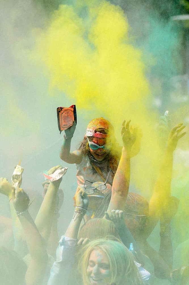 People throw colored powder during a Holi Festival in Yverdon-les-Bains, Switzerland.