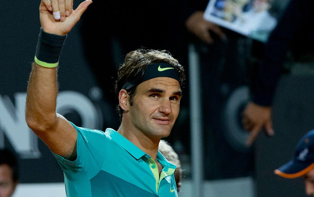 Roger Federer, of Switzerland, celebrates after beating his compatriot Stan Wawrinka in a semifinal match at the Italian Open tennis tournament, in Rome.