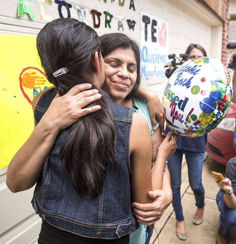 Alondra Diaz, 13, left, embraces her mother, Dorotea Garcia, after Diaz was returned to the United States, following an 8-year cross-border custody case, in Fresno, Texas.