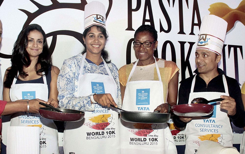 Three time Olympic gold medalist and TCS World 10k Brand Ambassador Marie Jose Perec with Athelete Anju Bobby George and Bollywood actors Rahul Bose and Gul Panag during a pasta party ahead of the marathon event in Bengaluru.