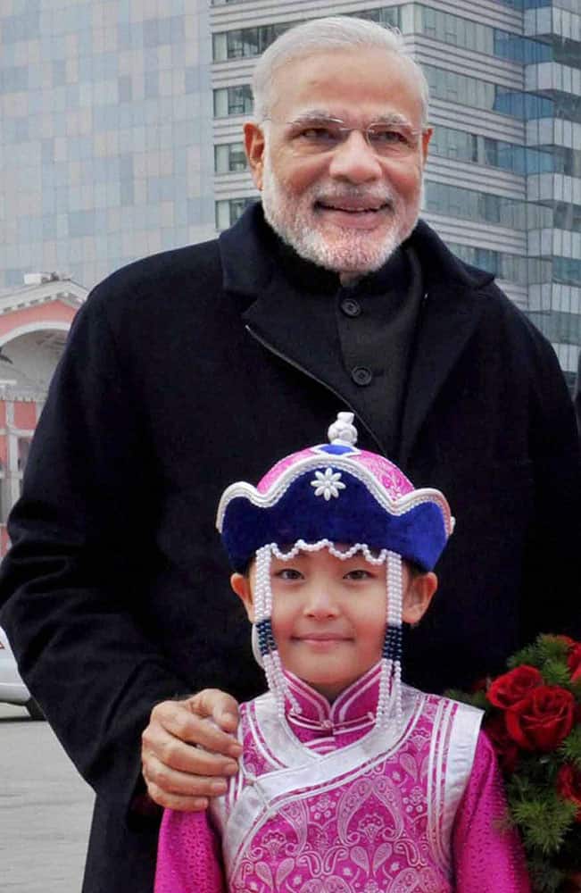 Ulan Bator: Prime Minster Narendra Modi with Mongolian child during the ceremonial welcome at State Palace in Ulan Bator, Mongolia.