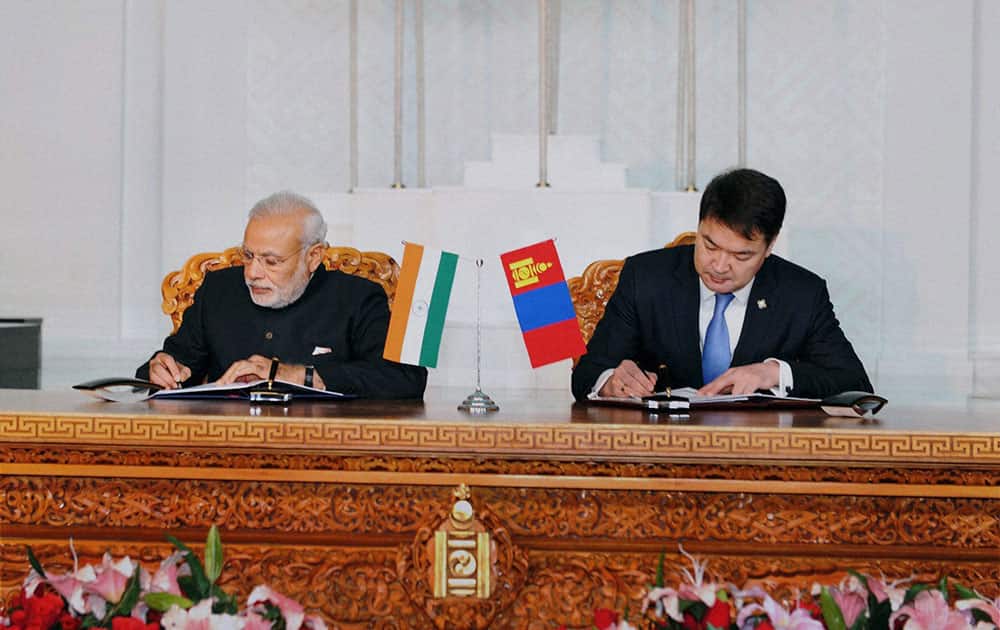 Prime Minster Narendra Modi with his Mongolian counterpart Chimed Saikhanbileg signing an agreements at State Palace in Ulan Bator, Mongolia.