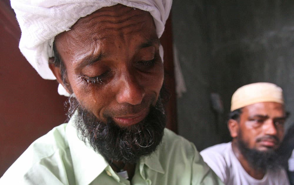 A Bangladeshi migrant weeps during the visit of Bangladesh's Ambassador to Indonesia Mohammad Nazmul Quaunine at a temporary shelter in Langsa, Aceh province, Indonesia