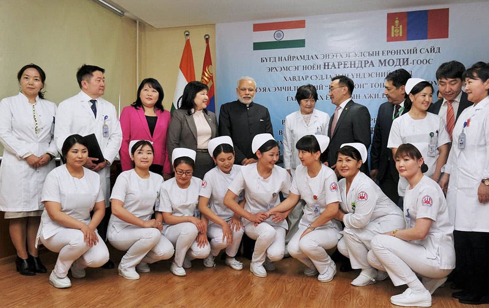 Prime Minister Narendra Modi pose a group photo with the staff of National Cancer Center of Mongolia, in Ulan Bator, Mongolia.