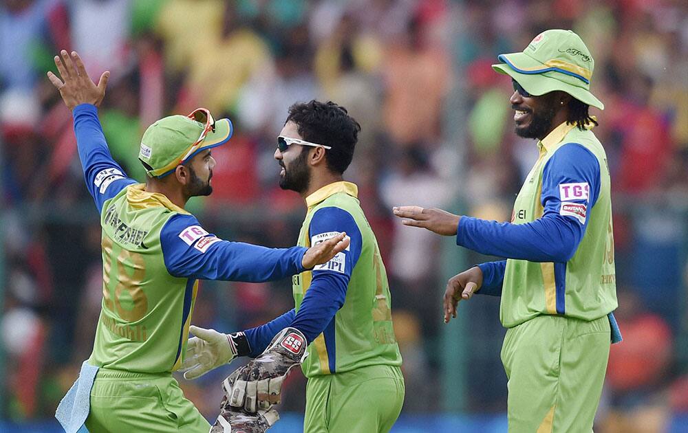 Royal Challengers Bangalore Captain Virat Kohli and Chris Gayle celebrates wicket of Shreyas Iyer during IPL8 match against Delhi Daredevils in Bengaluru.