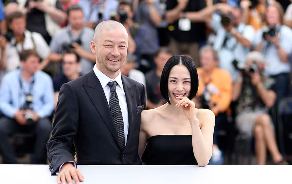 Actors Tadanobu Asano, left, and Eri Fukatsu pose for photographers during a photo call for the film Carol, at the 68th international film festival, Cannes.