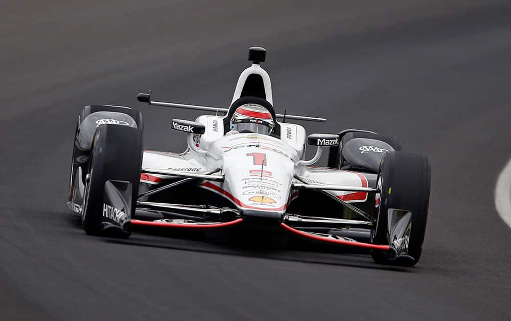 Will Power, of Australia, drives through the first turn during practice before qualifications for the Indianapolis 500 auto race at Indianapolis Motor Speedway in Indianapolis.